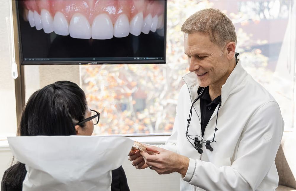 Dr. Marashi showing patient model for veneers